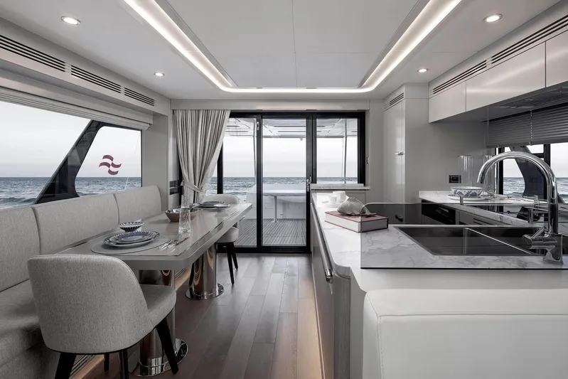  Yacht Photos Pics Luxurious interior of 2024 Sirena 68 yacht with modern kitchen and dining area.