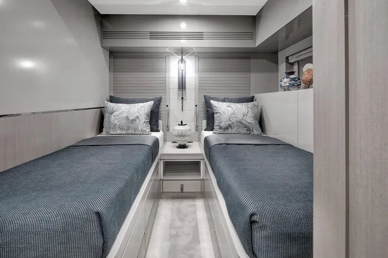  Yacht Photos Pics Luxurious twin cabin interior of 2024 Sirena 68 yacht, featuring elegant bedding and modern decor.