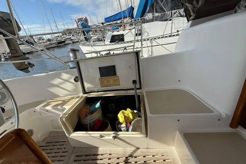 Sarah Yacht Photos Pics Cabo Rico Cutter 45 (2000) cockpit with open storage compartment, docked at marina.
