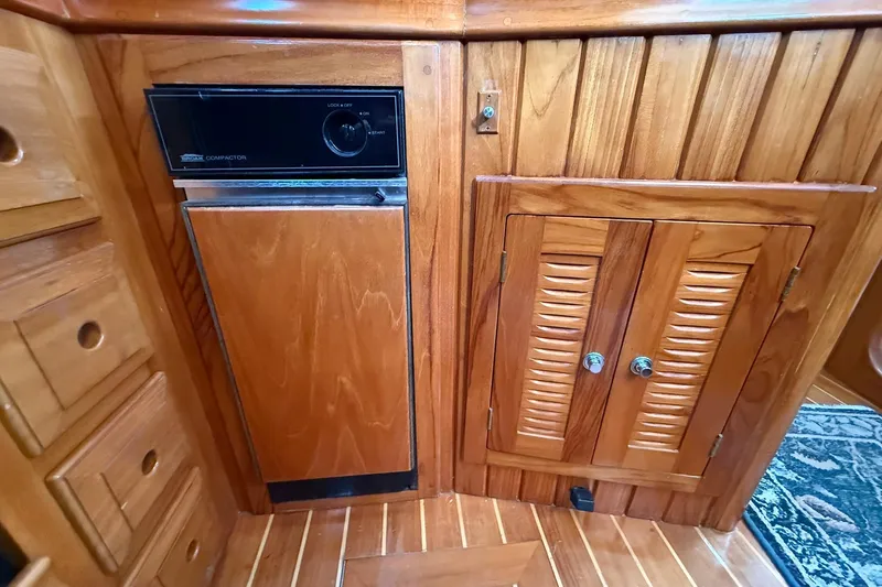 Sarah Yacht Photos Pics Wooden interior of 2000 Cabo Rico Cutter 45 with built-in trash compactor.