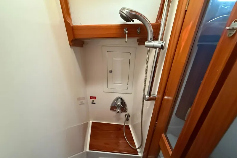 Sarah Yacht Photos Pics Cabo Rico Cutter 45 (2000) yacht shower with wooden accents and handheld showerhead.
