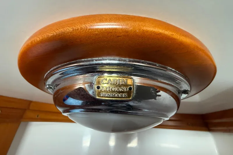 Sarah Yacht Photos Pics Cabo Rico Cutter 45 (2000) cabin light fixture with wooden and metal design.