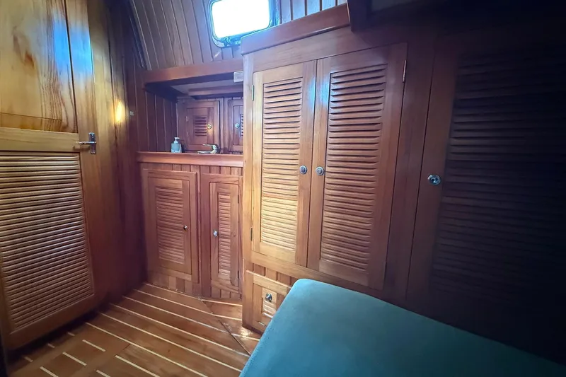 Sarah Yacht Photos Pics Interior of 2000 Cabo Rico Cutter 45 with wooden cabinetry and cozy design.