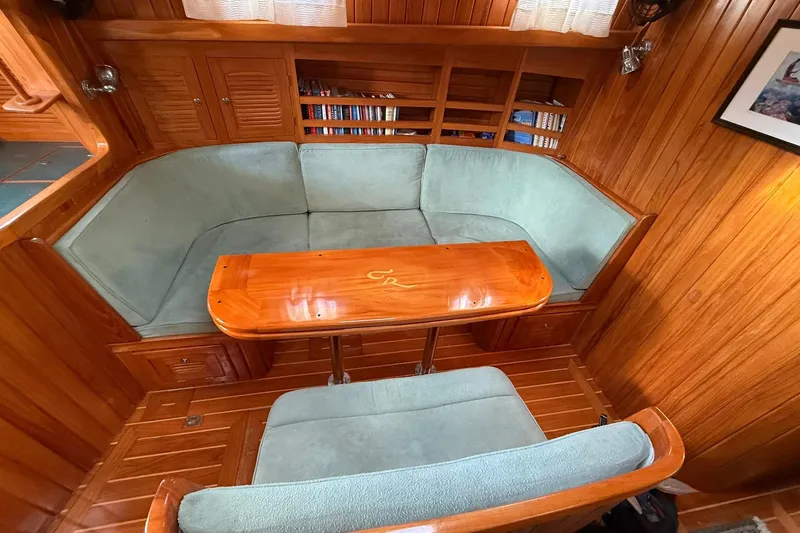 Sarah Yacht Photos Pics Cabo Rico Cutter 45 (2000) interior with wooden paneling and cozy seating area.