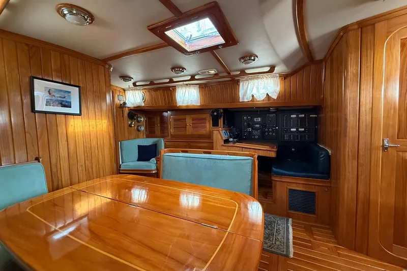 Sarah Yacht Photos Pics Luxurious interior of 2000 Cabo Rico Cutter 45 sailboat with wood paneling and seating.