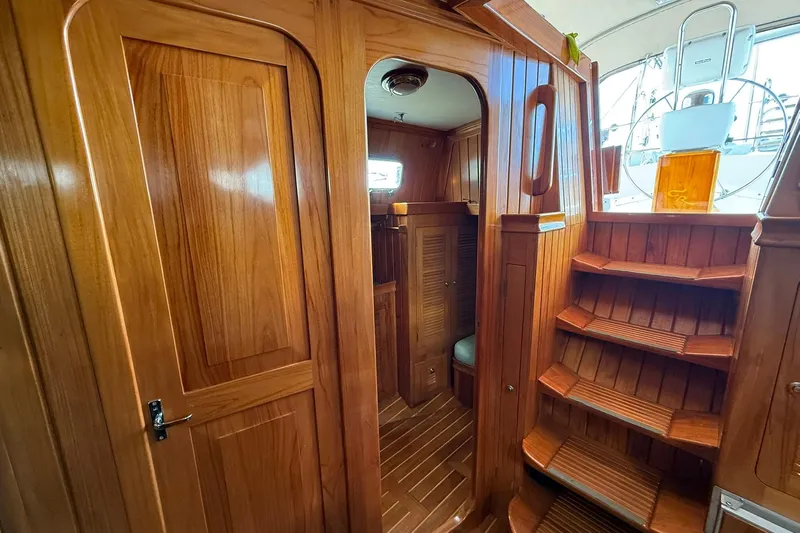 Sarah Yacht Photos Pics Interior of 2000 Cabo Rico Cutter 45 with polished wooden finish and staircase.