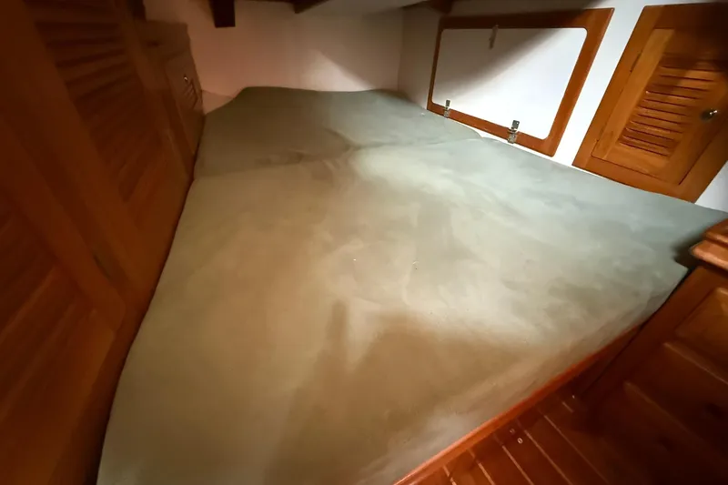 Sarah Yacht Photos Pics Interior cabin of 2000 Cabo Rico Cutter 45 with wooden accents and spacious bed.