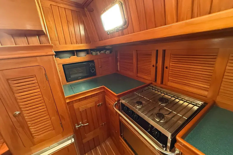 Sarah Yacht Photos Pics Cabo Rico Cutter 45 yacht kitchen with wooden cabinetry and modern appliances, 2000 model.