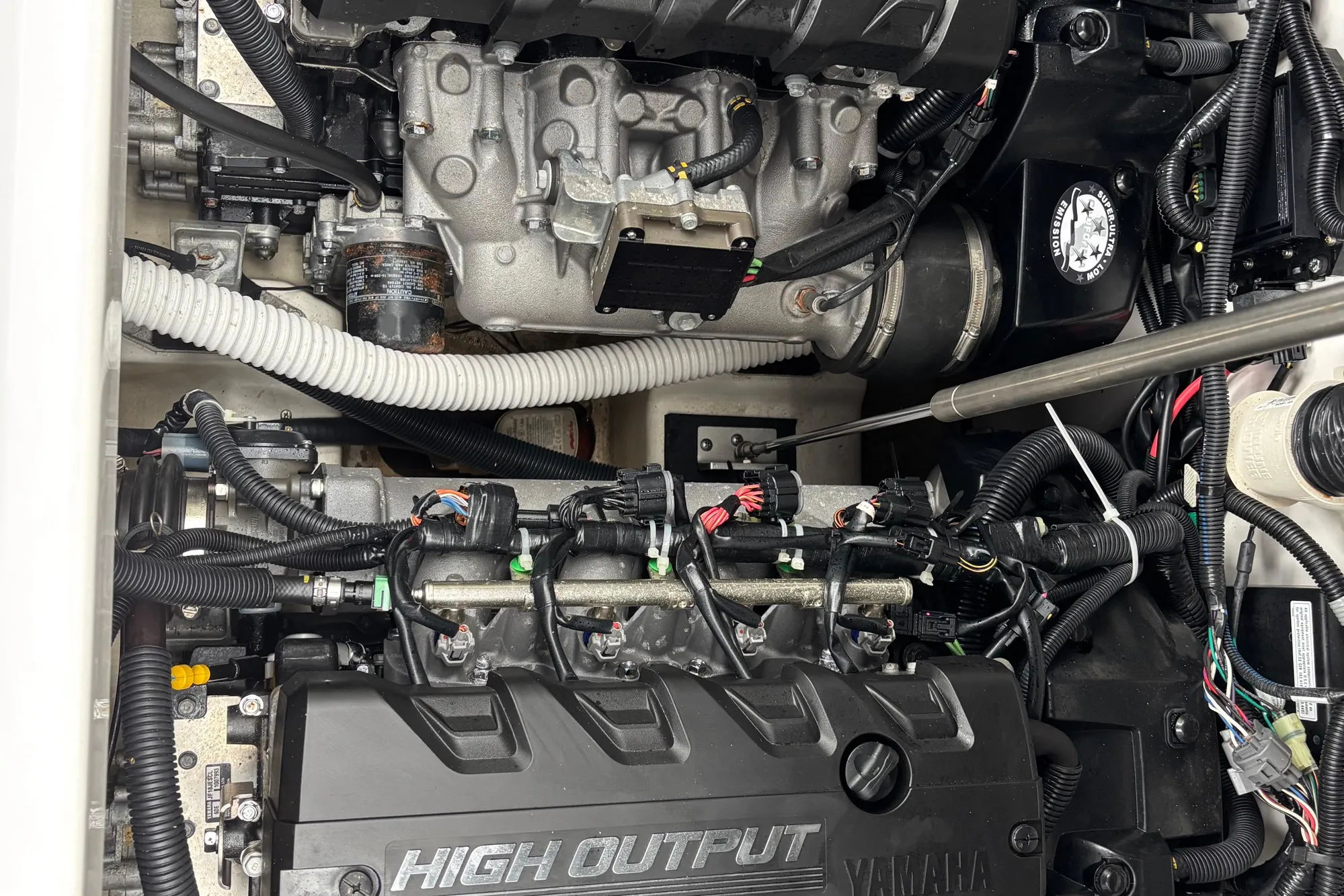 Engine compartment of 2022 Yamaha Boats 252S, showcasing high output components and wiring.