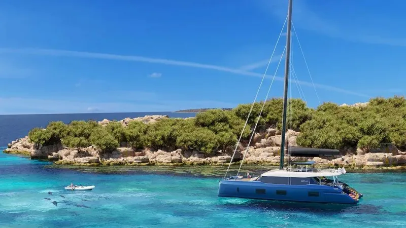  Yacht Photos Pics Luxurious 2026 Sunreef 100 yacht anchored near a scenic, lush island.