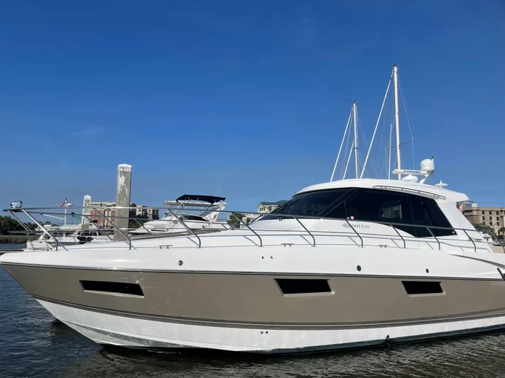 Seaquell Yacht Photos Pics 2012 Cruisers Yachts 48 Cantius on water, clear sky background.
