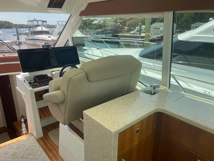 Seaquell Yacht Photos Pics Interior helm of 2012 Cruisers Yachts 48 Cantius with modern controls and seating.