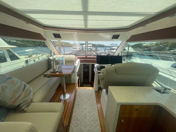 Seaquell Yacht Photos Pics Luxurious interior of 2012 Cruisers Yachts 48 Cantius with plush seating and helm.