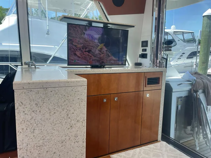 Seaquell Yacht Photos Pics Luxurious interior of 2012 Cruisers Yachts 48 Cantius with TV and cabinetry.