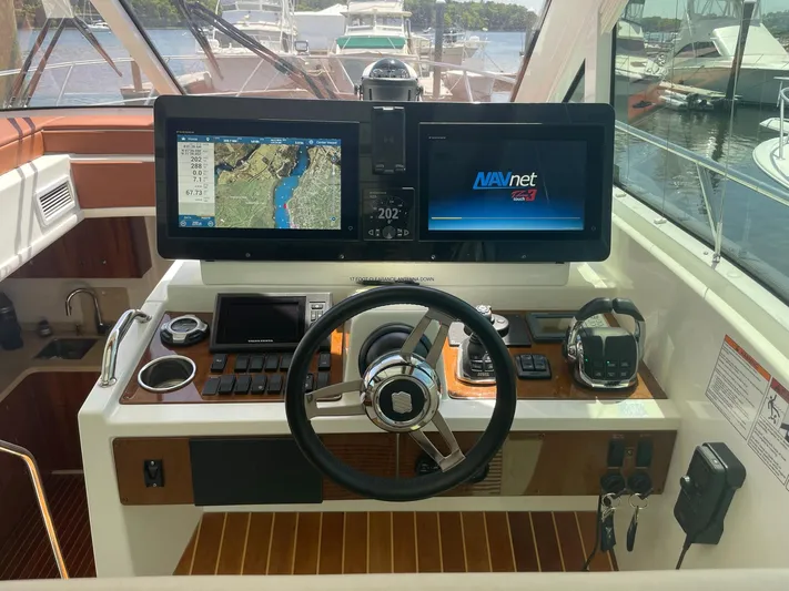 Seaquell Yacht Photos Pics Helm of 2012 Cruisers Yachts 48 Cantius with navigation screens and controls.