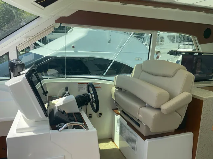 Seaquell Yacht Photos Pics Interior helm of 2012 Cruisers Yachts 48 Cantius with plush seating and modern controls.