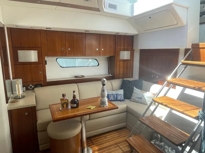 Seaquell Yacht Photos Pics Luxurious interior of 2012 Cruisers Yachts 48 Cantius with cozy seating and wooden accents.