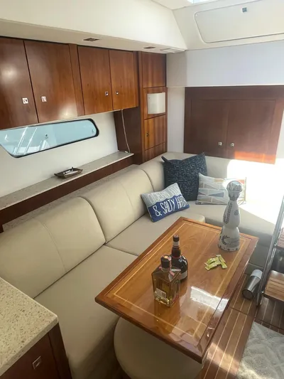 Seaquell Yacht Photos Pics Luxurious interior of 2012 Cruisers Yachts 48 Cantius with elegant seating and wooden cabinetry.