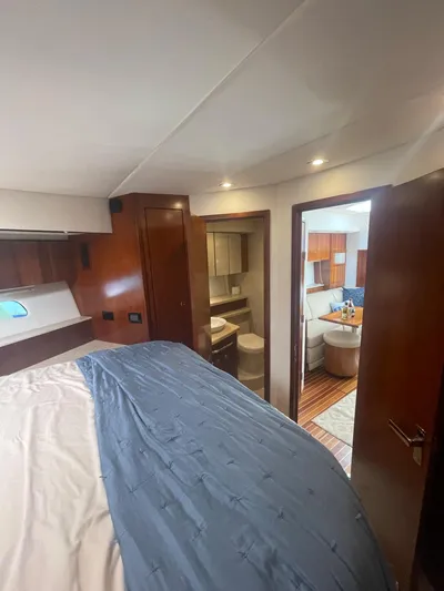 Seaquell Yacht Photos Pics Luxurious 2012 Cruisers Yachts 48 Cantius interior with elegant wood finishes and cozy bedroom.