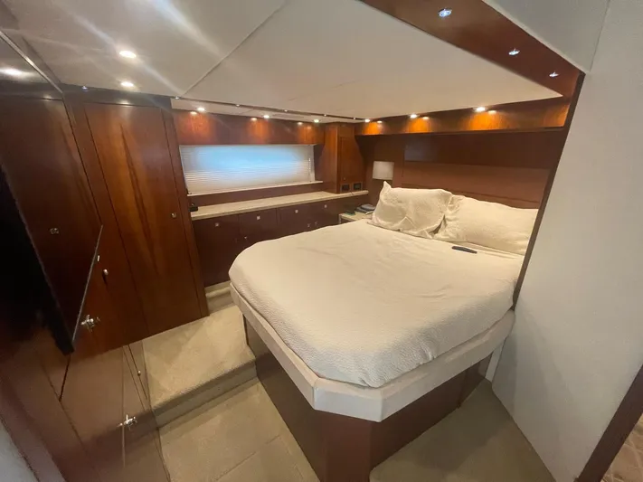 Seaquell Yacht Photos Pics Luxurious bedroom interior of 2012 Cruisers Yachts 48 Cantius with elegant wood finishes.