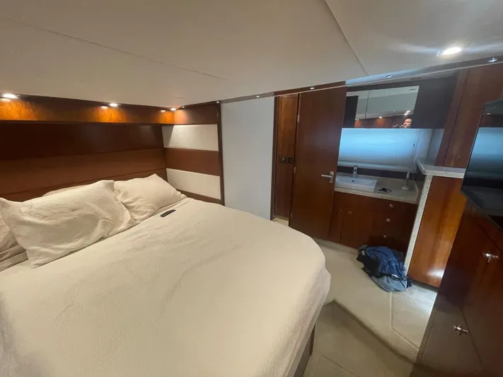 Seaquell Yacht Photos Pics Luxurious bedroom interior of 2012 Cruisers Yachts 48 Cantius with elegant wood finishes.