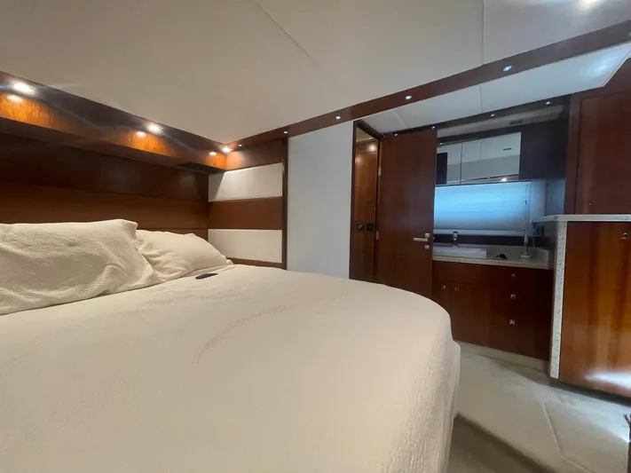 Seaquell Yacht Photos Pics Luxurious bedroom interior of 2012 Cruisers Yachts 48 Cantius with wood accents and cozy bedding.