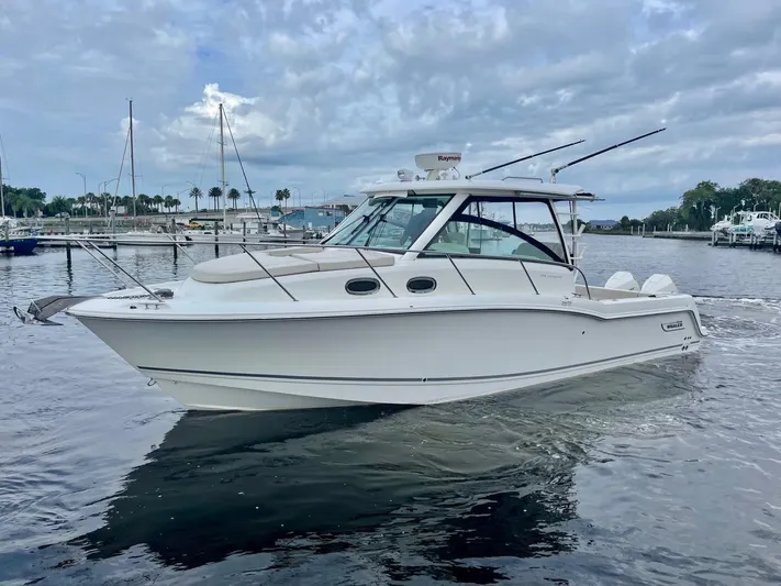  Yacht Photos Pics 2016 Boston Whaler 315 Conquest boat docked in a marina.