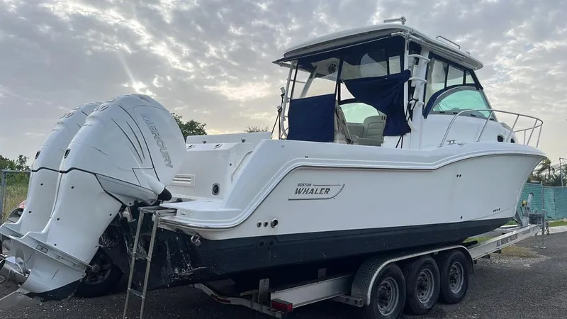  Yacht Photos Pics 2016 Boston Whaler 315 Conquest boat on a trailer with twin outboard engines.