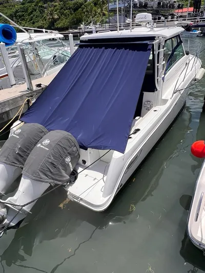  Yacht Photos Pics 2016 Boston Whaler 315 Conquest docked with blue canopy and twin engines.