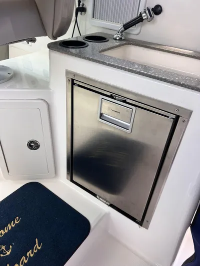  Yacht Photos Pics 2016 Boston Whaler 315 Conquest boat galley with sink and refrigerator.