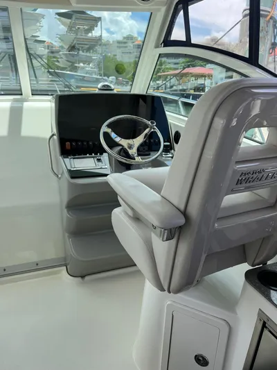  Yacht Photos Pics 2016 Boston Whaler 315 Conquest helm station with steering wheel and captain's chair.