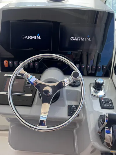  Yacht Photos Pics 2016 Boston Whaler 315 Conquest helm with Garmin navigation displays.