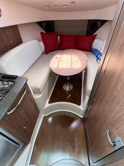  Yacht Photos Pics 2016 Boston Whaler 315 Conquest cabin interior with seating and table.