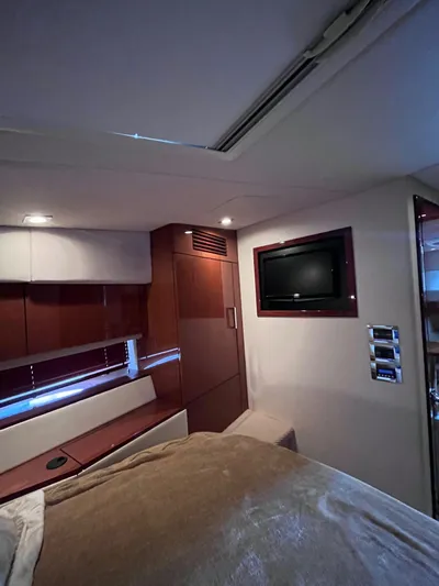 Zingaro Yacht Photos Pics Interior cabin of 2013 Sea Ray 450 Sundancer yacht with TV and wood paneling.