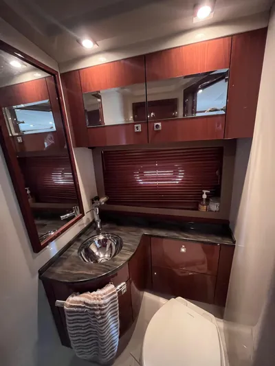 Zingaro Yacht Photos Pics Luxurious bathroom interior of 2013 Sea Ray 450 Sundancer yacht with wood cabinetry and modern fixtures.