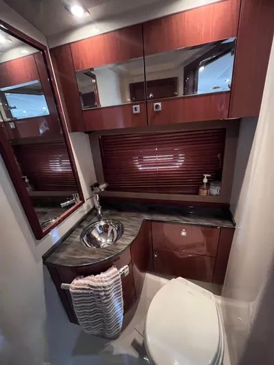 Zingaro Yacht Photos Pics Luxurious bathroom in 2013 Sea Ray 450 Sundancer yacht with wood cabinetry and modern fixtures.