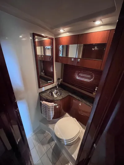 Zingaro Yacht Photos Pics Luxurious bathroom in 2013 Sea Ray 450 Sundancer yacht with modern fixtures and wood accents.