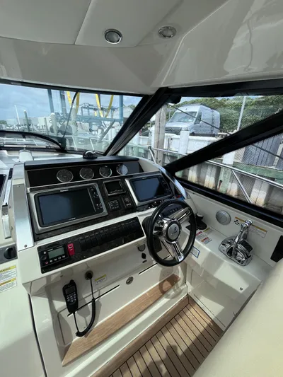 Zingaro Yacht Photos Pics 2013 Sea Ray 450 Sundancer helm with modern controls and navigation systems.