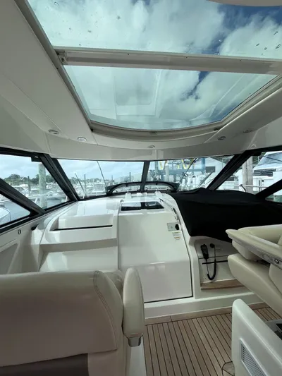 Zingaro Yacht Photos Pics Interior view of 2013 Sea Ray 450 Sundancer yacht with glass roof and modern helm.