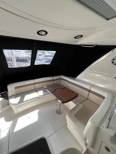 Zingaro Yacht Photos Pics Interior of 2013 Sea Ray 450 Sundancer yacht with seating and table.