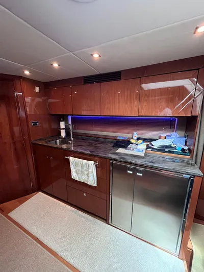 Zingaro Yacht Photos Pics Luxurious kitchen area in 2013 Sea Ray 450 Sundancer yacht with modern cabinetry and lighting.