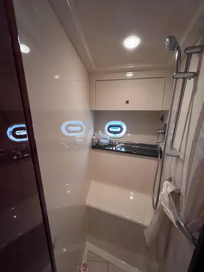 Zingaro Yacht Photos Pics Luxurious bathroom in 2013 Sea Ray 450 Sundancer yacht with modern fixtures and porthole windows.