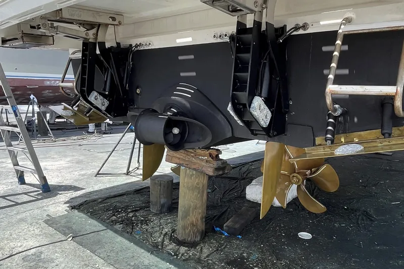 Salty Cowboy Yacht Photos Pics 2022 Princess 55 Flybridge yacht under maintenance, showcasing propellers and stern details.