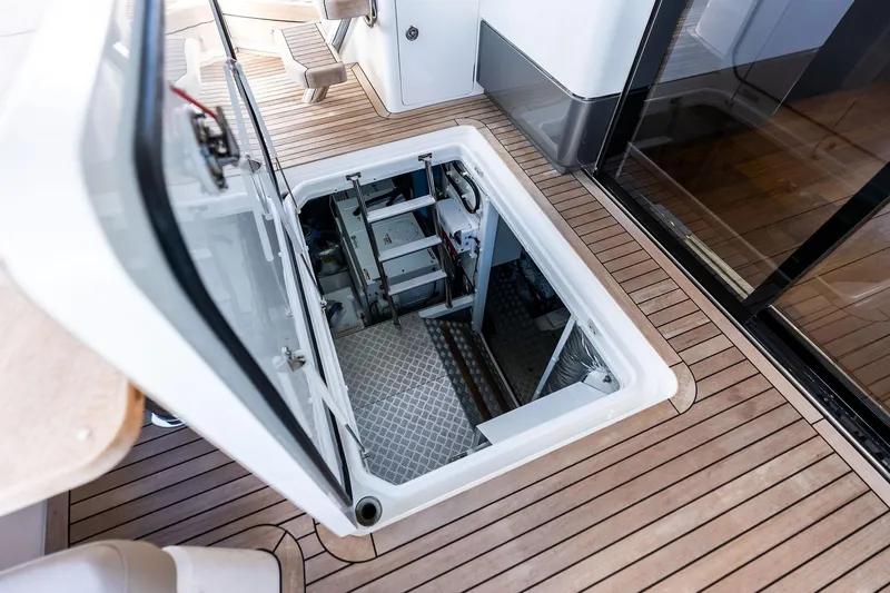 Salty Cowboy Yacht Photos Pics Engine room access on 2022 Princess 55 Flybridge yacht with teak flooring.