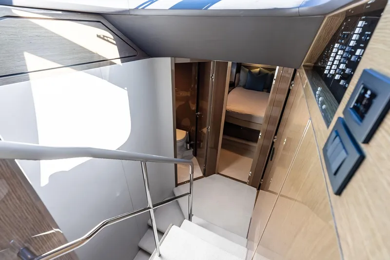 Salty Cowboy Yacht Photos Pics Interior view of 2022 Princess 55 Flybridge yacht, featuring modern staircase and luxurious cabin.