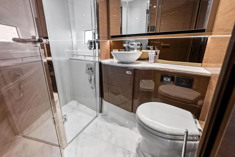 Salty Cowboy Yacht Photos Pics Luxurious bathroom in 2022 Princess 55 Flybridge yacht with modern fixtures and elegant design.