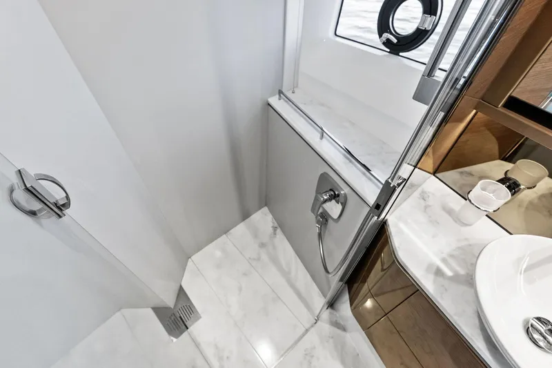 Salty Cowboy Yacht Photos Pics Luxurious bathroom interior on 2022 Princess 55 Flybridge yacht, featuring marble surfaces and modern fixtures.
