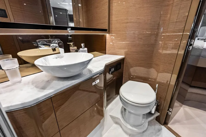 Salty Cowboy Yacht Photos Pics Luxurious bathroom in 2022 Princess 55 Flybridge yacht with modern fixtures and elegant design.