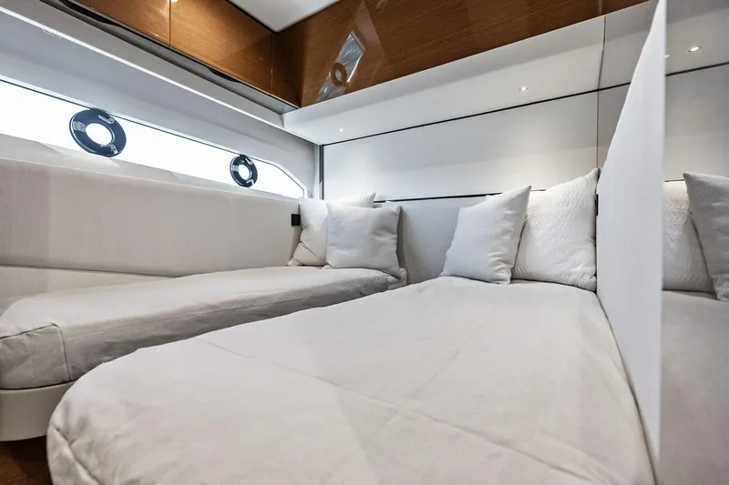Salty Cowboy Yacht Photos Pics Luxurious interior of 2022 Princess 55 Flybridge yacht with elegant bedding and modern design.
