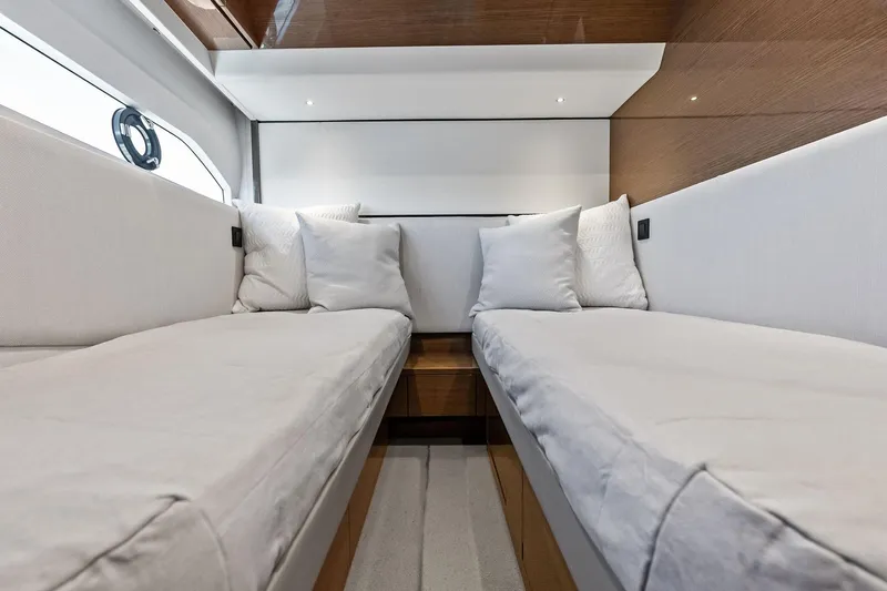 Salty Cowboy Yacht Photos Pics Luxurious interior of 2022 Princess 55 Flybridge yacht with twin beds and elegant decor.